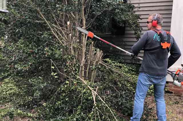 The Sunnyside Sisters Bed and Breakfast / Clarksville VA / Martijn trimmingbthe bushes at the front of the house