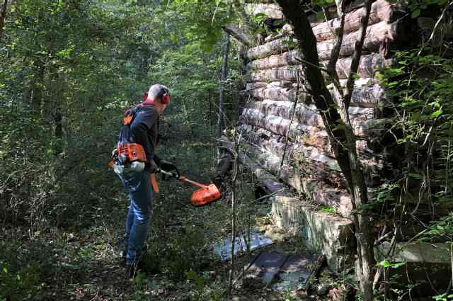 The Sunnyside Sisters Bed and Breakfast / Clarksville VA / M making a path next to one of the Tabocco log houses