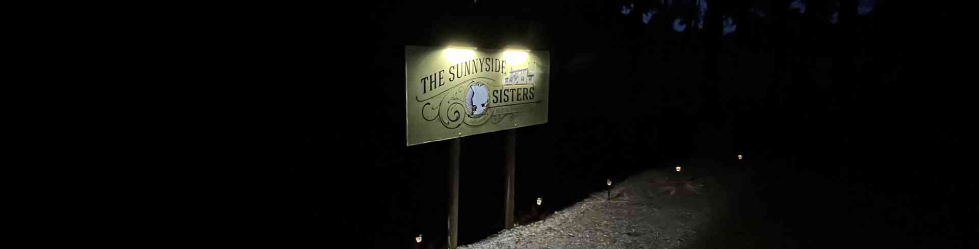 The Sunnyside Sisters Bed and Breakfast / Clarksville VA / Sunnyside Sisters B&B sign from left side, at night